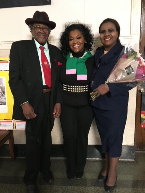 A FLORAL BOUQUET was presented by the Sorors of Gamma Psi Omega in memory of Soror Katie Hall. Pictured on the second floor of Gary City Hall from, l-r: Deacon Emeritus Attorney John Henry Hall, Ed.D., LL.M.; Vice-President Enrika Johnson, Gamma Psi Omega Chapter, AKA and Chairman and CEO Junifer Hall, JD, MPA, MBA, Katie Hall Educational Foundation, Inc.