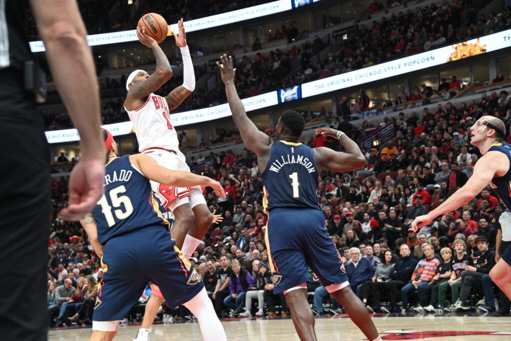 BULLS 13 F TAKES A JUMP SHOT OVER THE NEW ORLEANS PELICANS 1F ZION WILLIAMSON AND 15 JULIAN PHILIPS BULLS BEATS THE PELICANS 118 TO BULL